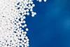 Numerous expanded polystyrene foam beads on a blue background