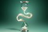 An hourglass that has been split in two and the sand swirls in the space between.