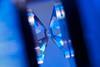 A crystal is placed under high pressure between two diamond tips in a diamond anvil cell