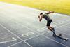 Man sprinting out of the blocks on a track