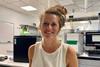 Emma Withers in a laboratory smiling. 