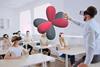 A teacher and students all wearing VR headsets examine an electron shell orbital diagram in 3d