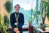 A teacher with some plants in his science classroom