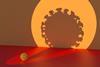 A spotlight on a small covid virus casting a large silhouette on a wall