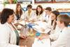 Group of teenage students in a science class with teacher