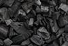 A close-up, full-frame photograph of pieces of charcoal
