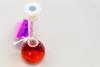 Volumetric flask containing red liquid with a label