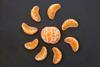 An image showing a tangerine in the centre surrounded by tangerine segments to illustrate the concept of segmenting and sequencing in teaching
