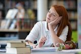 A high school student daydreaming in class