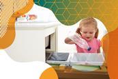 Photo of a young girl putting a plastic bottle into a household bin