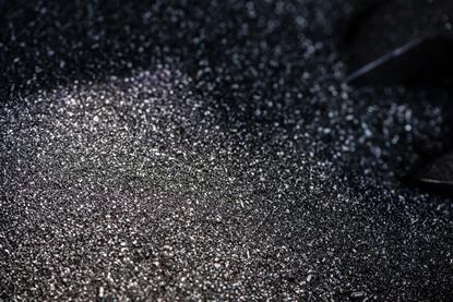 A macro photograph of silver-grey iron filings