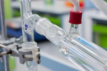 A close-up photograph of glass apparatus for evaporating and condensing liquids in the laboratory