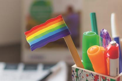 An image showing a LGBT mini flag inside pot of stationery