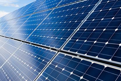 A picture showing solar panels with blue sky and white colours top left corner to illustrate an article about fuelling the future with hydrogen, solar and wind power