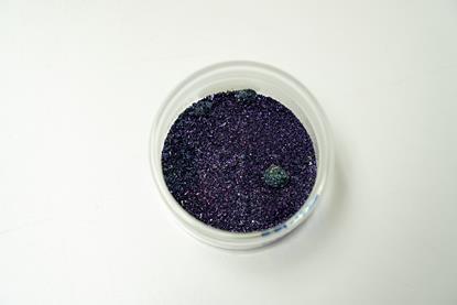 Crystals of potassium permanganate in a glass container