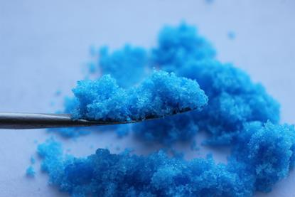 Copper sulfate crystals on a spatula 