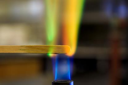 Copper solution soaked splint in Bunsen burner flame.