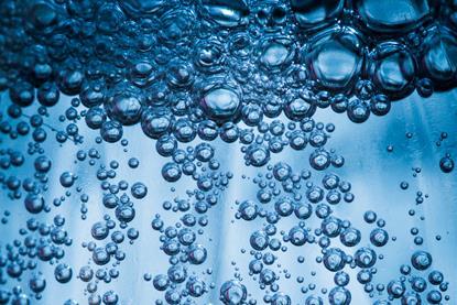 A close-up image of bubbles in fizzy water