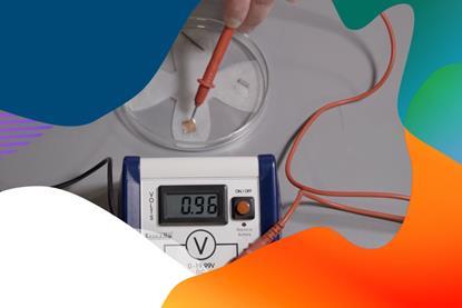 A Petri dish set up for a microscale electrolysis experiment using samples of metal and a power supply