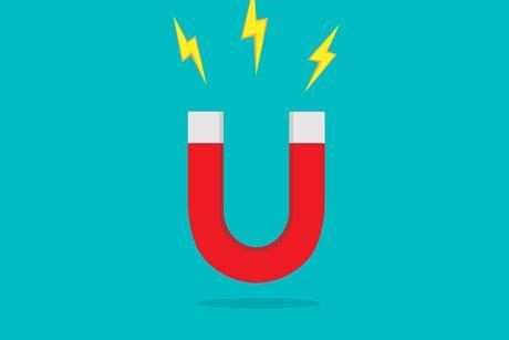 picture of a horse shoe red magnet on a blue background with yellow sparks coming out of it